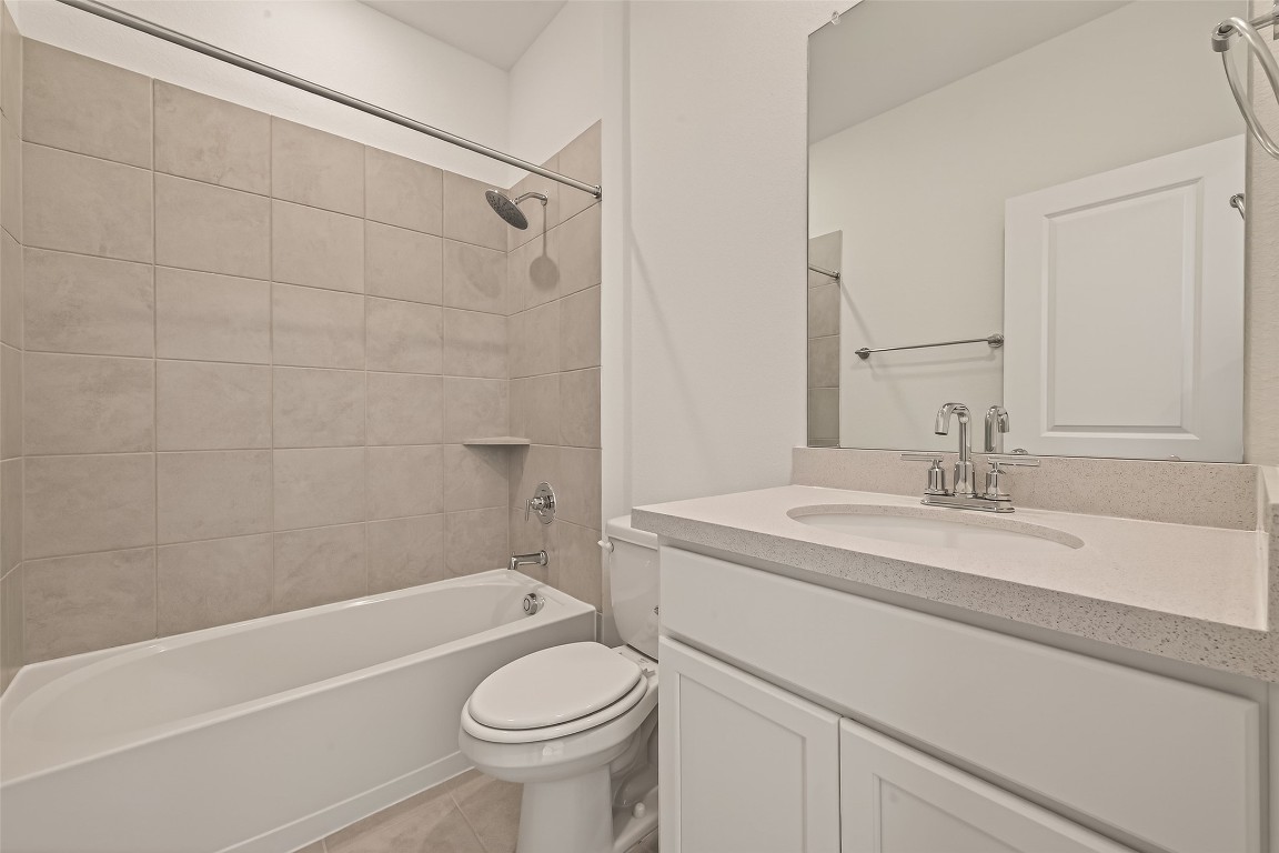 21926 Sam Raburn Drive Tomball, TX 77375 - Photo 20 of 47 a bathroom with a sink a toilet and a bathtub