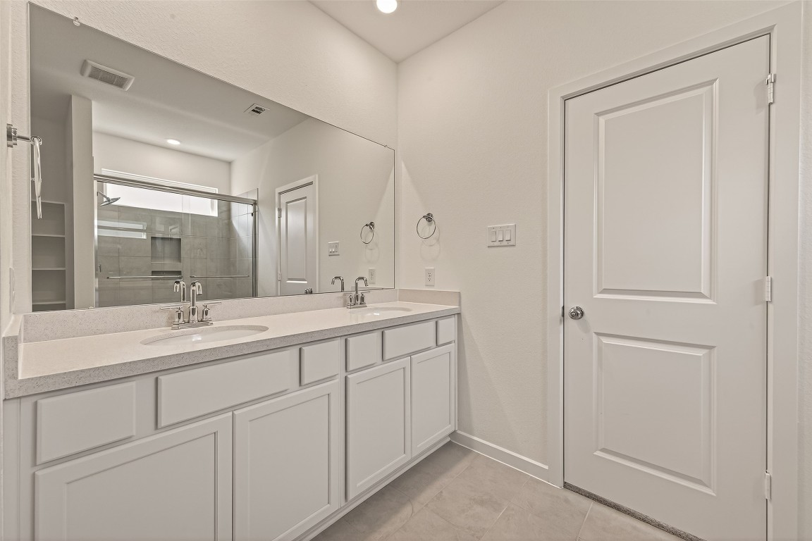 21926 Sam Raburn Drive Tomball, TX 77375 - Photo 38 of 47 a bathroom with double sink and a mirror