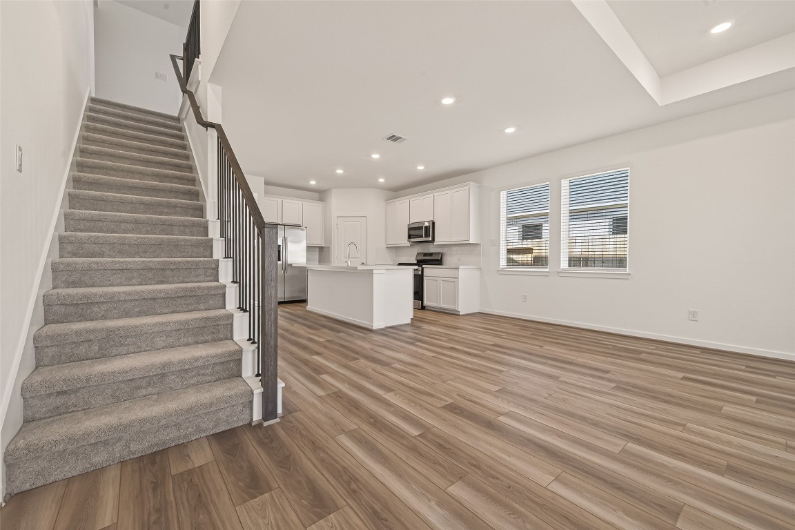 21926 Sam Raburn Drive Tomball, TX 77375 - Photo 5 of 47 a view of a room with wooden floor and stairs