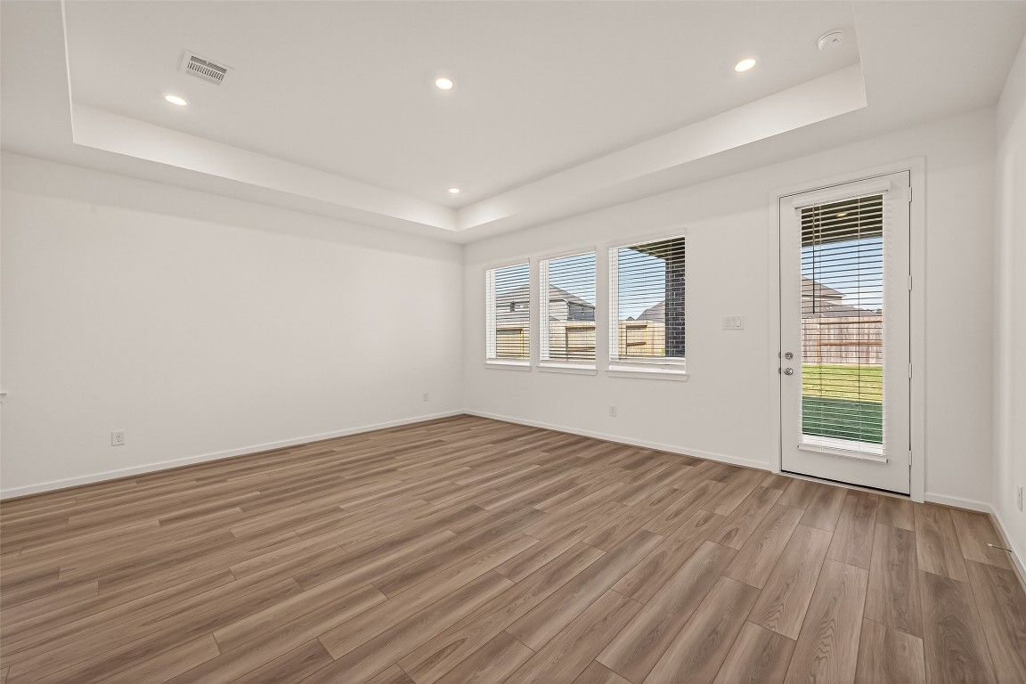 21926 Sam Raburn Drive Tomball, TX 77375 - Photo 6 of 47 an empty room with wooden floor and windows