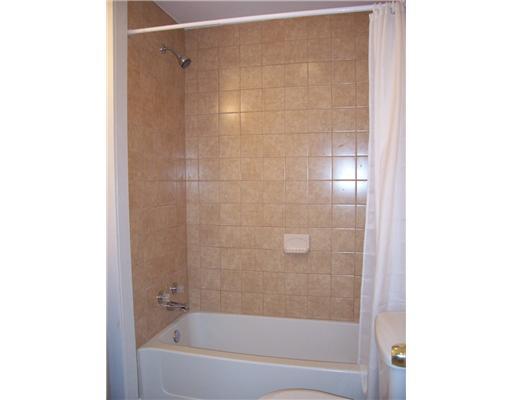3410 Conway Wallrose Road Economy, PA 15143 - Photo 10 of 18 Full Bath. The tub is surrounded by neutral ceramic tile and has a shower.