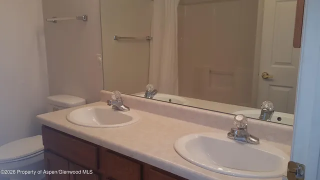 a view of a hardwood floor and an entryway