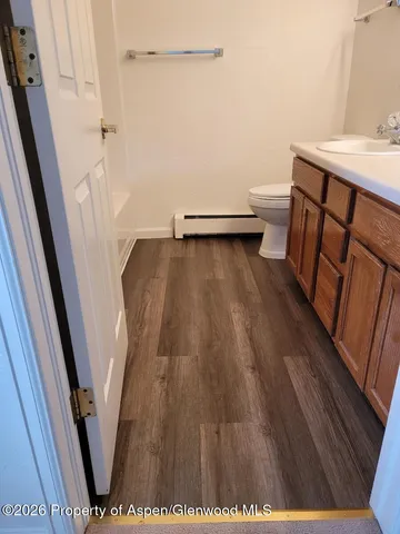 a spacious bathroom with a double vanity sink a toilet and a mirror