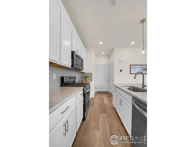 a kitchen with stainless steel appliances granite countertop a sink and cabinets