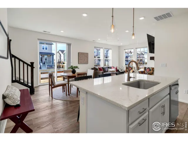 a kitchen with a sink cabinets and wooden floor