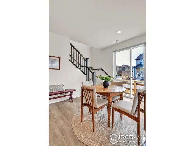 a dining room with furniture and a potted plant