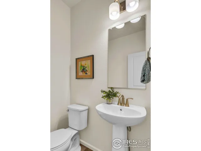 a bathroom with a sink a mirror and a toilet