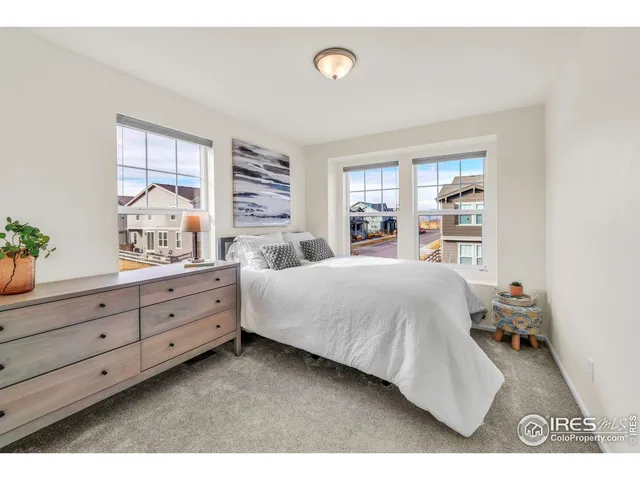 a spacious bedroom with a bed and window