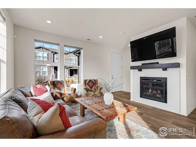 a living room with fireplace furniture and a flat screen tv