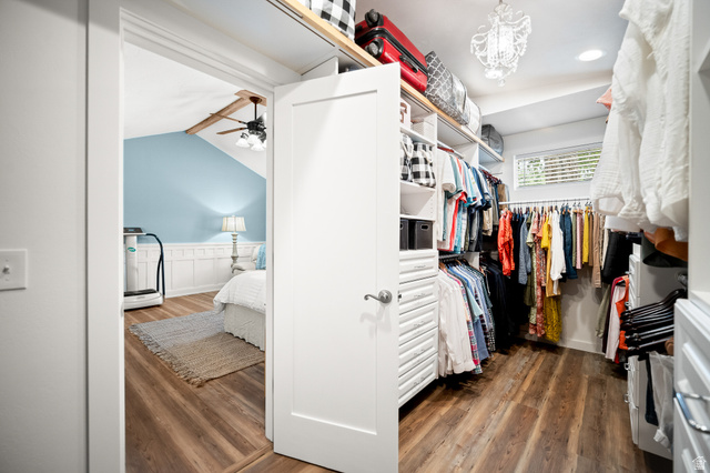 236 West 300 South Hurricane, UT 84737 - Photo 43 of 76 Spacious walk-in closet featuring wood-finish flooring, white built-in shelving, hanging storage, and a crystal chandelier