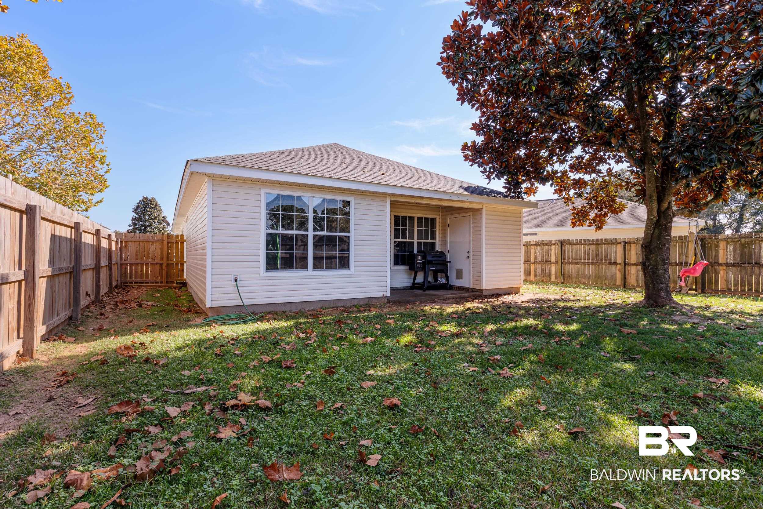 16227 Zenith Drive Loxley, AL 36551 - Photo 23 of 23 Rear view of house featuring a patio, a fenced backyard, and a shingled roof