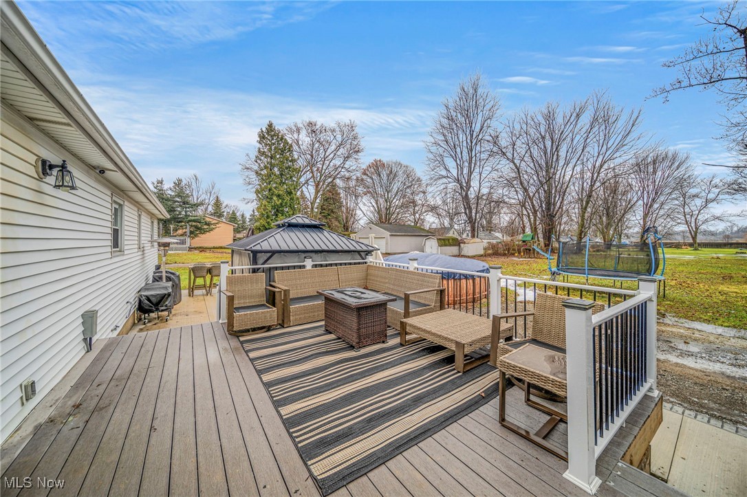 6600 Reynolds Road Mentor, OH 44060 - Photo 27 of 35 Wooden terrace featuring a gazebo, an outdoor living space with a fire pit, and a trampoline