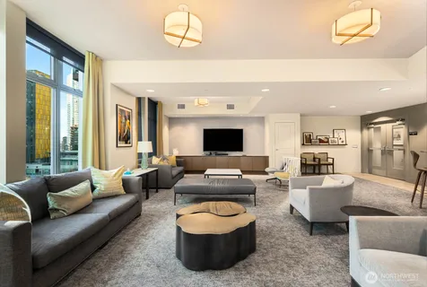 a living room with lots of furniture and kitchen view