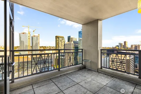 a spacious bedroom with a bed and a large window