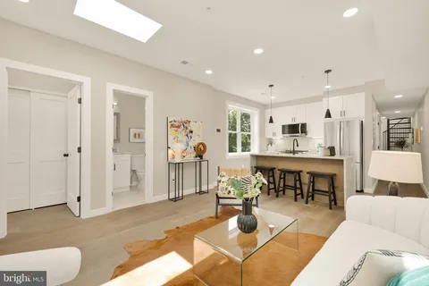 a living room with lots of furniture and kitchen view