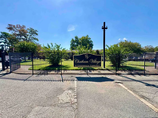 a view of a park with iron fence