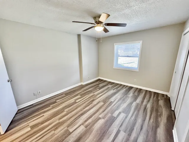a view of room with window and ceiling fan