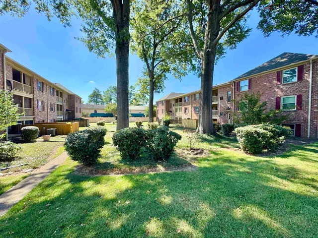 a view of a house with a yard and street