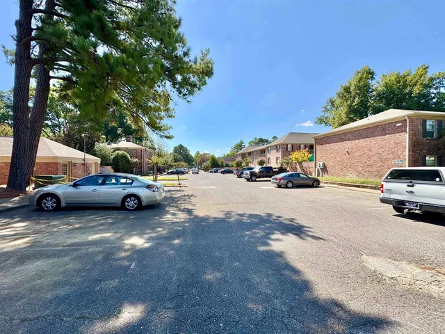 a view of cars parked on the side of a street