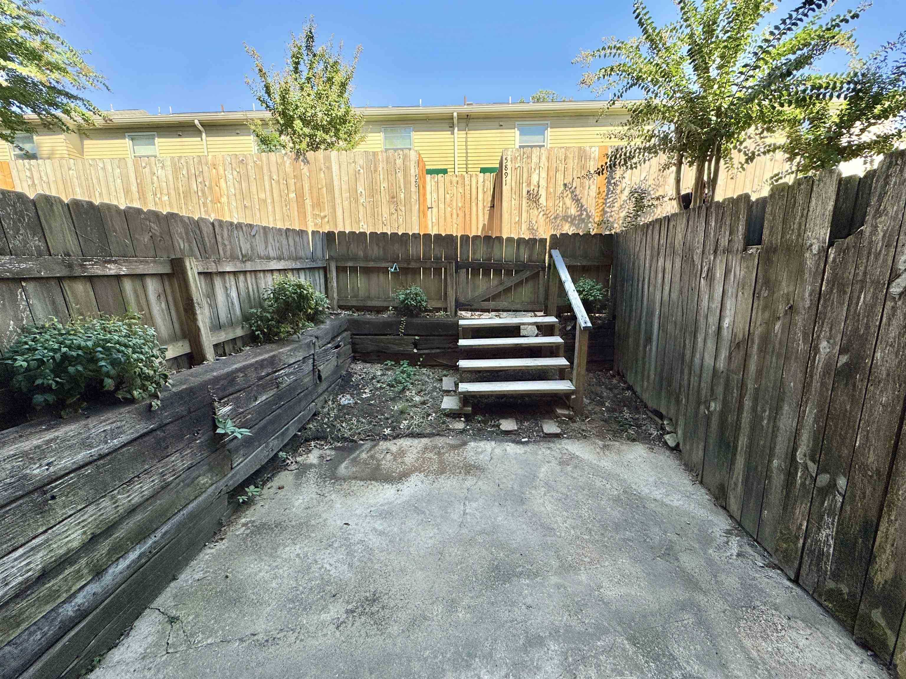 1202 Middle Court, Unit 101 Memphis, TN 38119 - Photo 20 of 24 a view of house with backyard and wooden fence