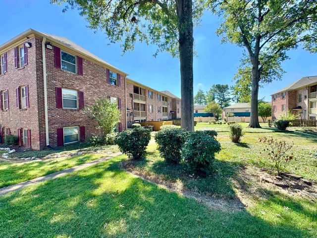 a view of a house with a yard and tree s