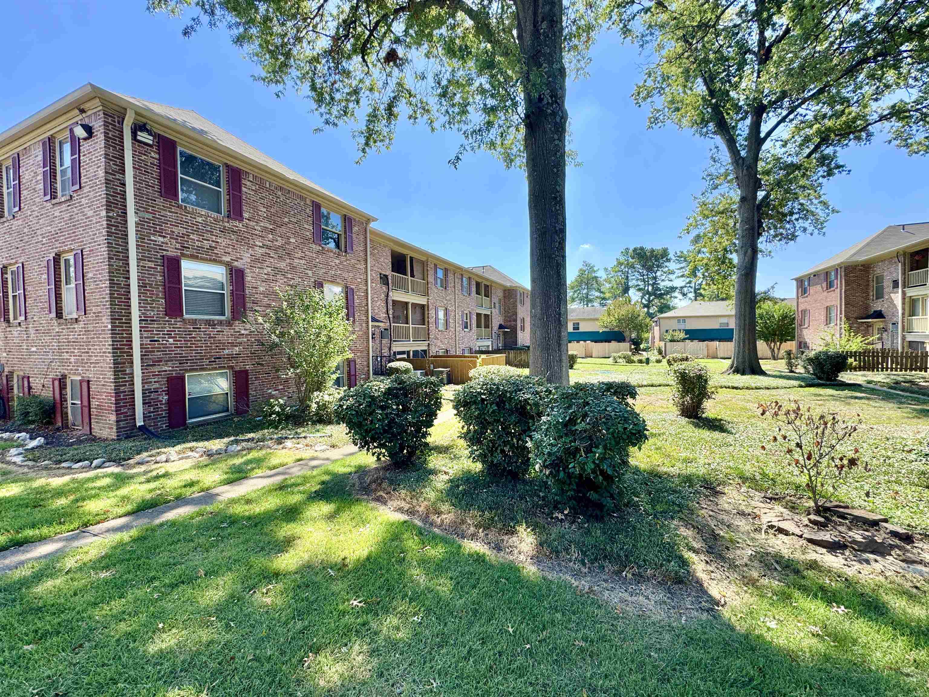 1202 Middle Court, Unit 101 Memphis, TN 38119 - Photo 2 of 24 a view of a house with a yard and tree s