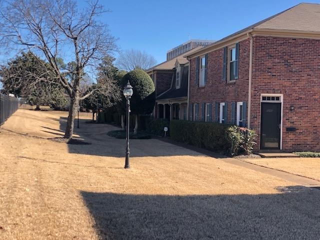 1202 Middle Court, Unit 101 Memphis, TN 38119 - Photo 23 of 24 a front view of a house with a yard