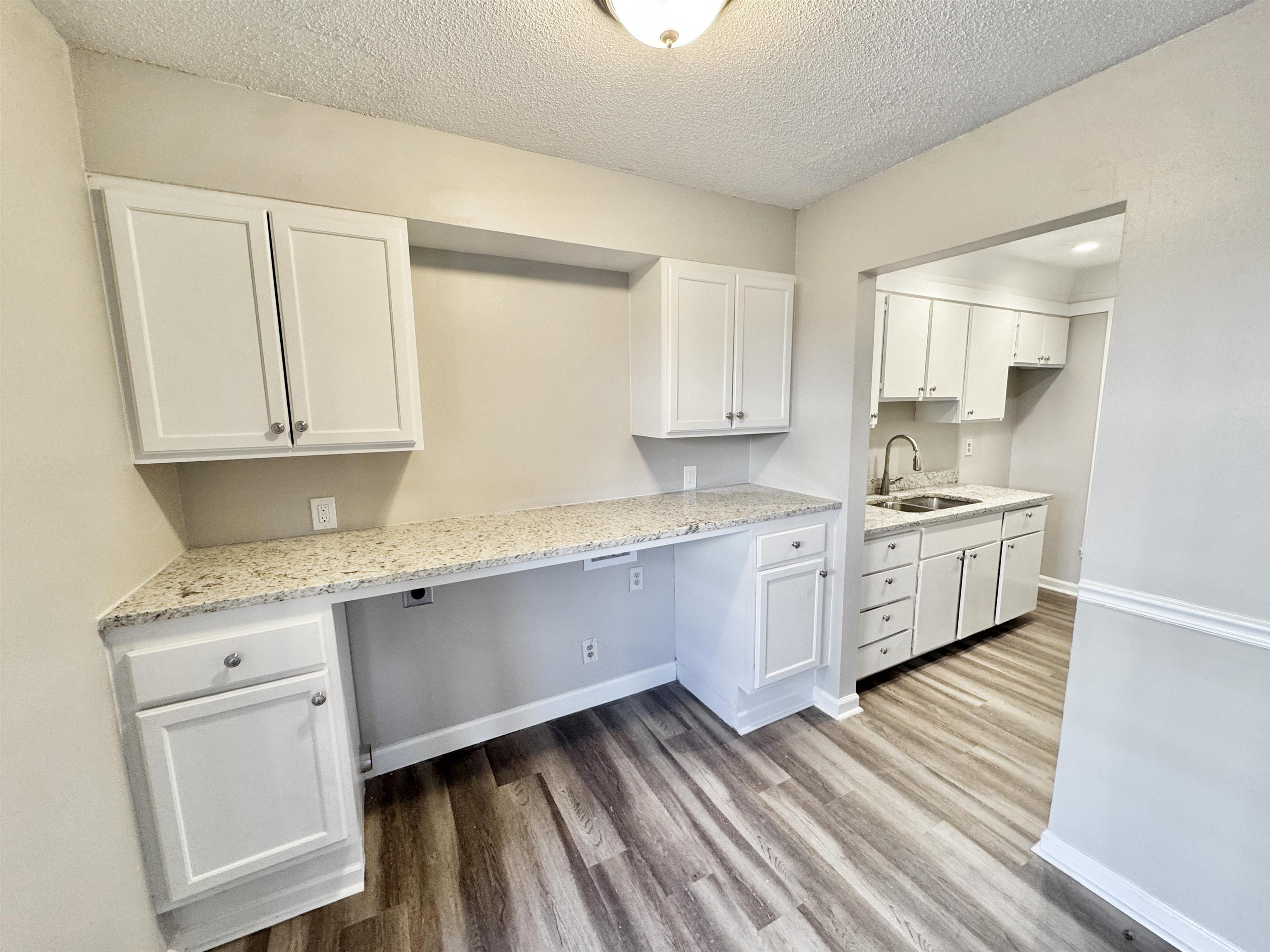 1202 Middle Court, Unit 101 Memphis, TN 38119 - Photo 7 of 24 a kitchen with granite countertop white cabinets and white appliances