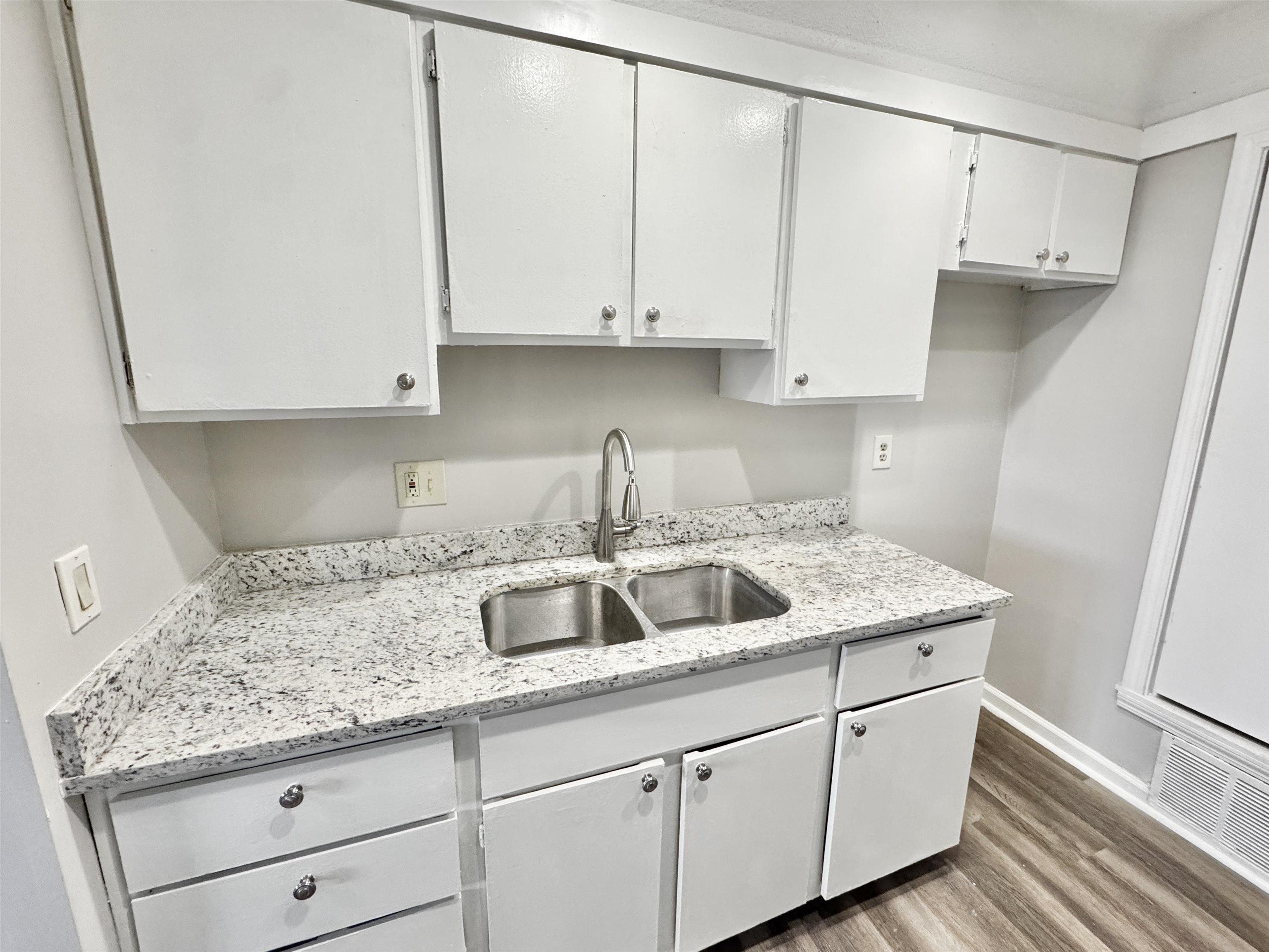 1202 Middle Court, Unit 101 Memphis, TN 38119 - Photo 8 of 24 a kitchen with granite countertop white cabinets and sink