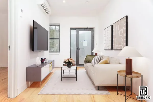 a living room with furniture and a flat screen tv
