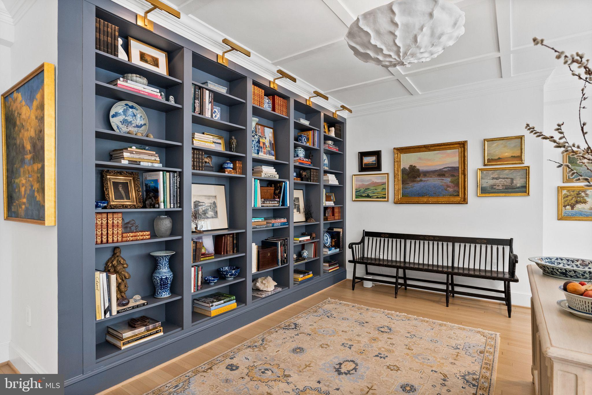 1661 Crescent Place Northwest, Unit 305 Washington, DC 20009 - Photo 3 of 25 a living room with lots of furniture and a book shelf