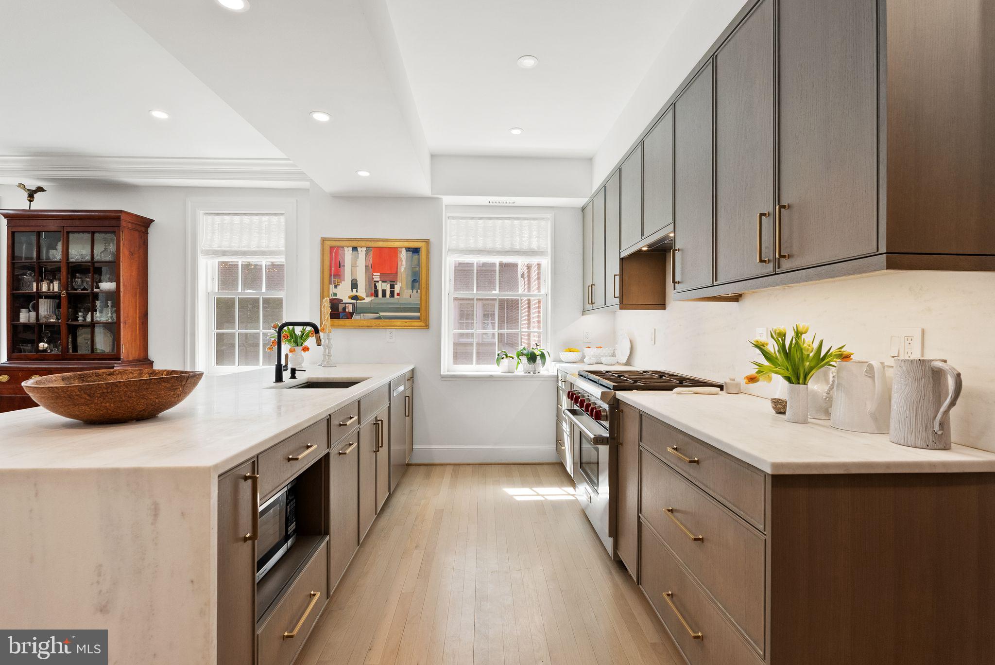 1661 Crescent Place Northwest, Unit 305 Washington, DC 20009 - Photo 7 of 25 a kitchen with a sink stove and cabinets