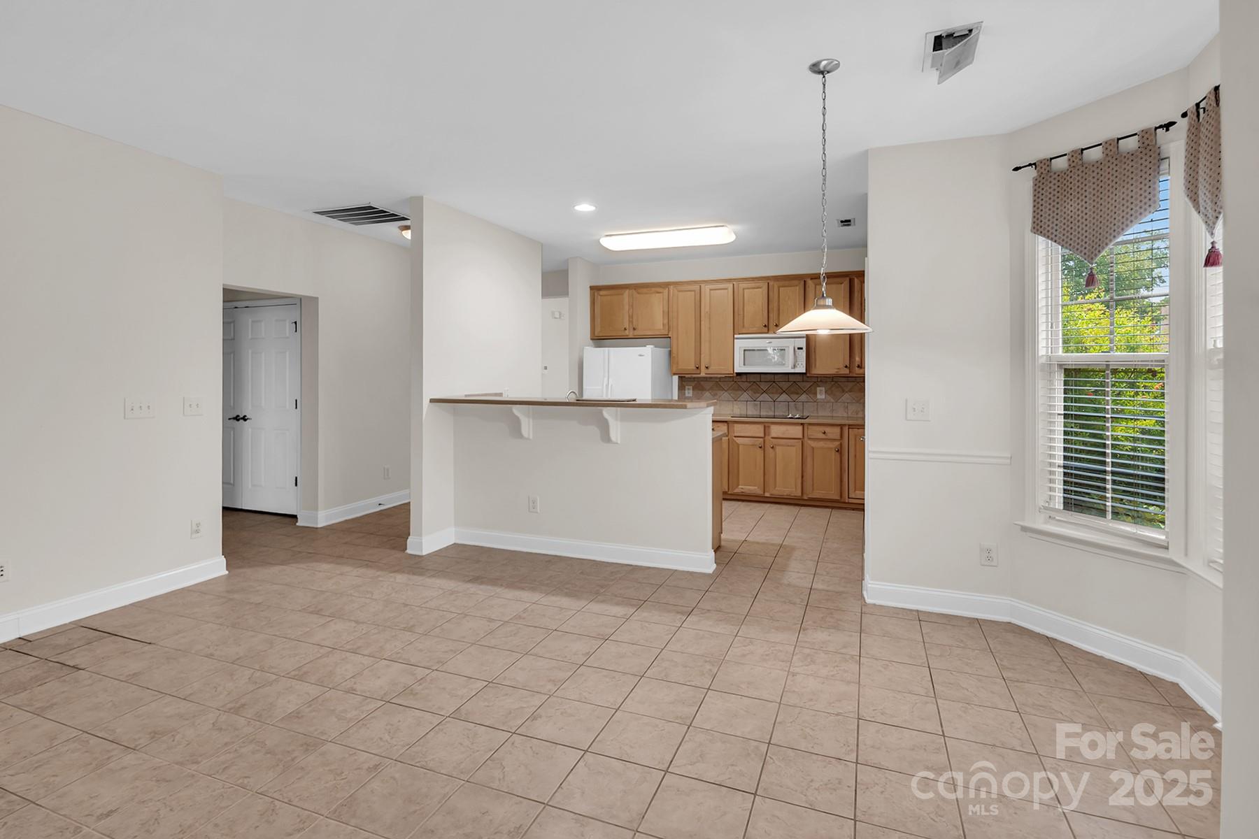 923 Platinum Drive Fort Mill, SC 29708 - Photo 9 of 34 a view of a kitchen with a sink and dishwasher a refrigerator with white cabinets