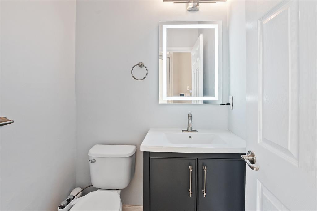 816 West Village Circle, Unit 1 Davie, FL 33325 - Photo 11 of 27 a bathroom with a toilet sink and mirror