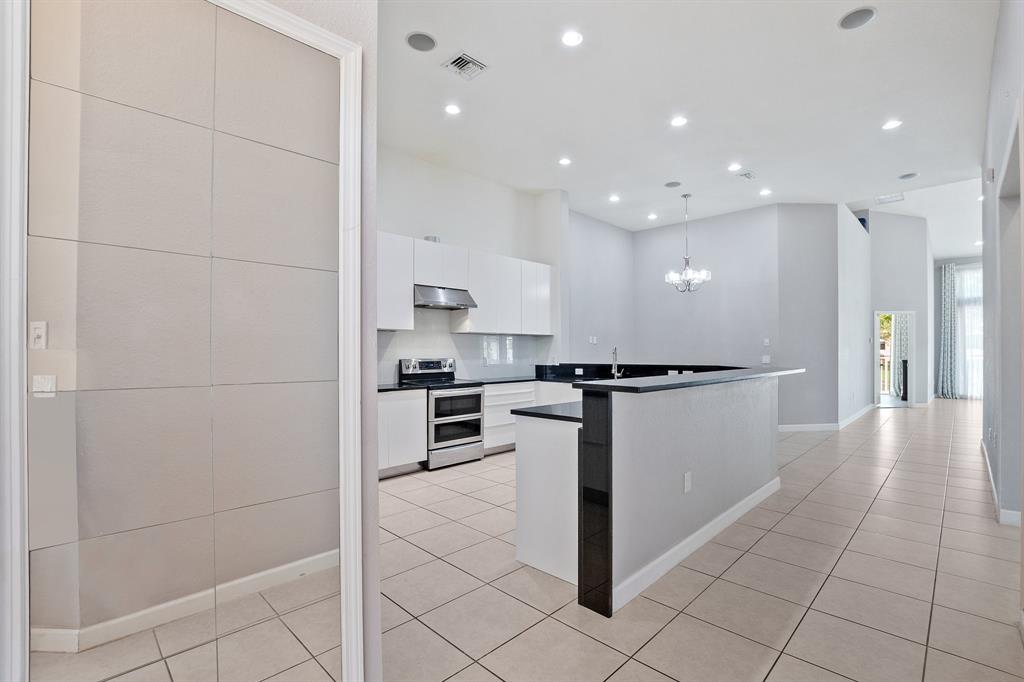 816 West Village Circle, Unit 1 Davie, FL 33325 - Photo 3 of 27 a kitchen with a refrigerator and a stove top oven