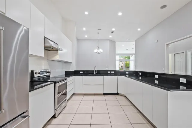 a kitchen with a sink a stove and refrigerator