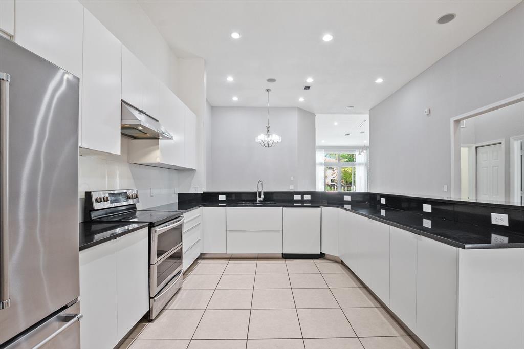 816 West Village Circle, Unit 1 Davie, FL 33325 - Photo 4 of 27 a kitchen with a sink a stove and refrigerator