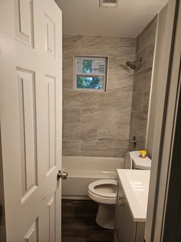 a bathroom with a toilet sink and shower