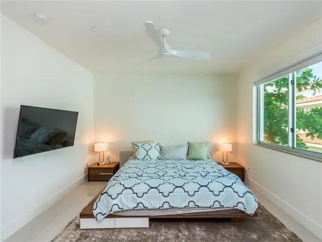 a bedroom with a bed and a flat tv screen