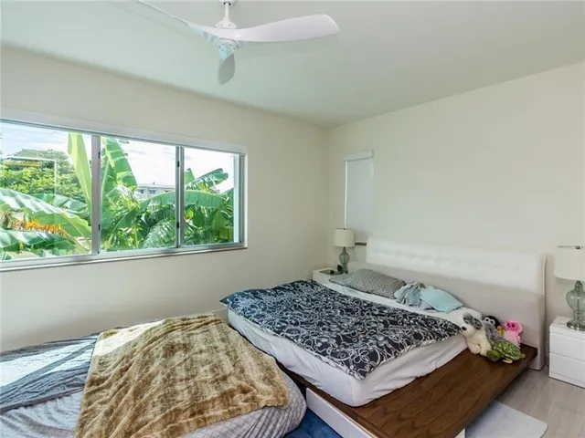 a bed sitting in a bedroom next to a window