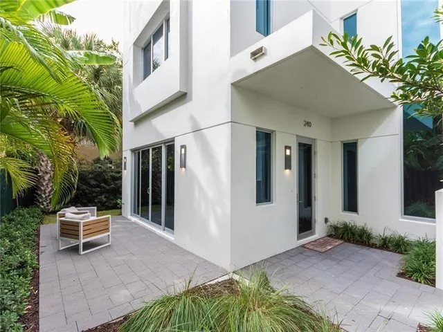 a backyard of a house with outdoor seating