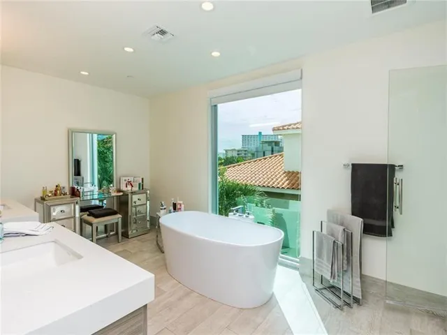 a living room with furniture a large window and a flat screen tv