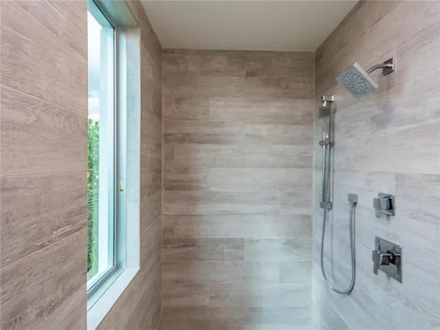 a bathroom with a glass shower door