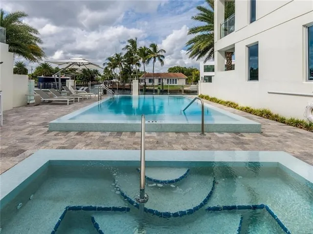 a view of swimming pool with a lounge chairs