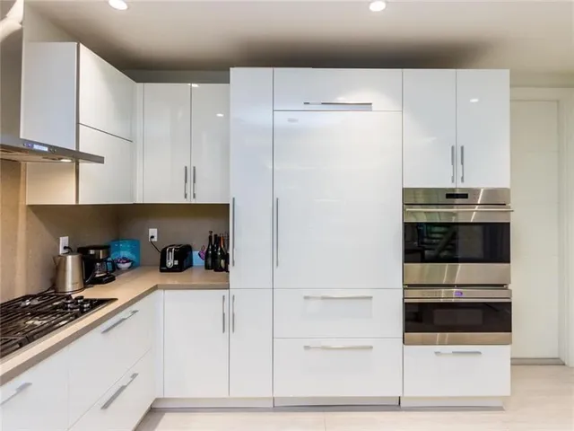a kitchen with stainless steel appliances a stove and a refrigerator