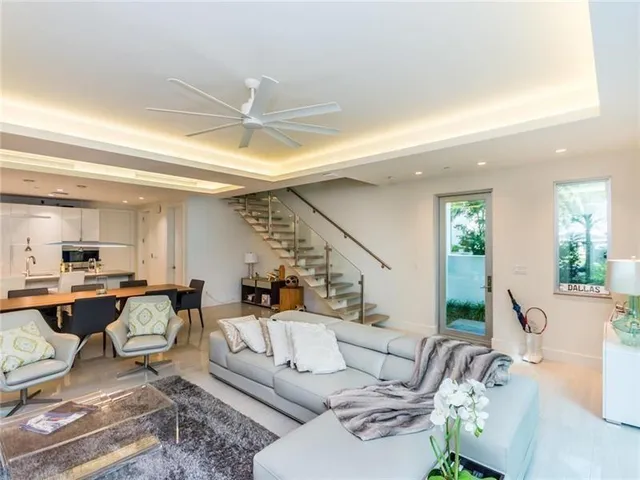 a living room with furniture and view of kitchen