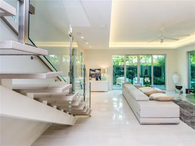 a living room with furniture and a floor to ceiling window