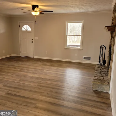 a view of a livingroom with wooden floor and a window
