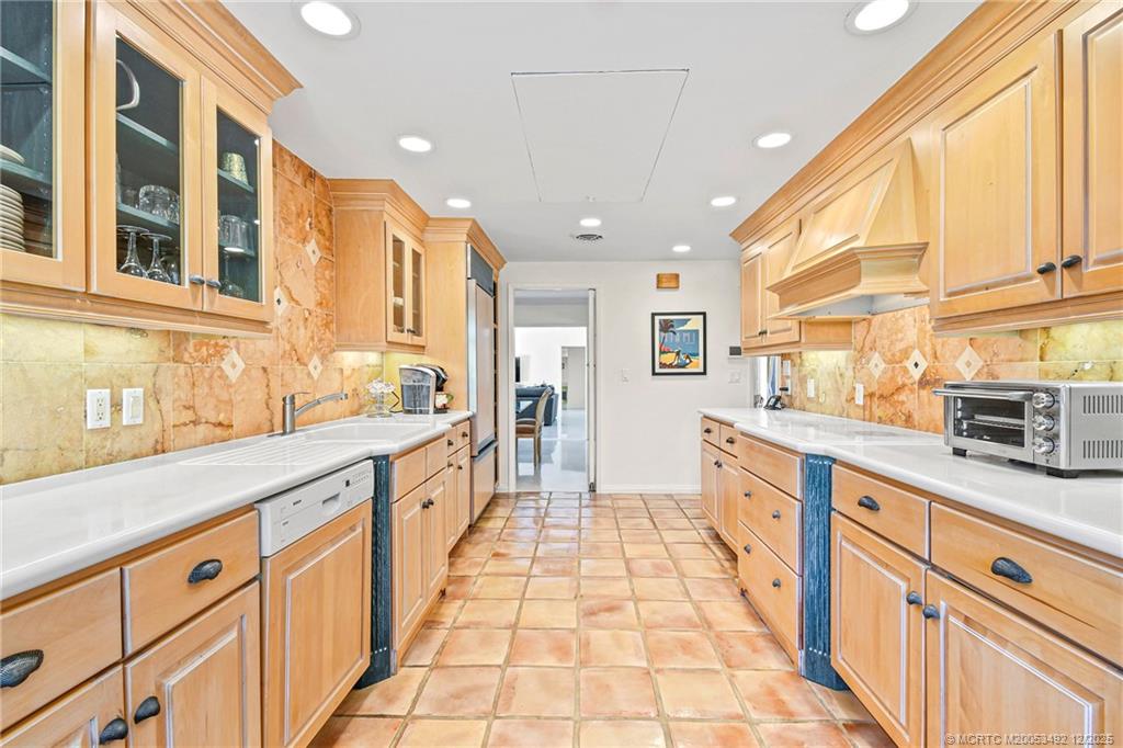 229 Colony Road Jupiter, FL 33469 - Photo 12 of 52 a large kitchen with stainless steel appliances granite countertop a large counter top and a stove