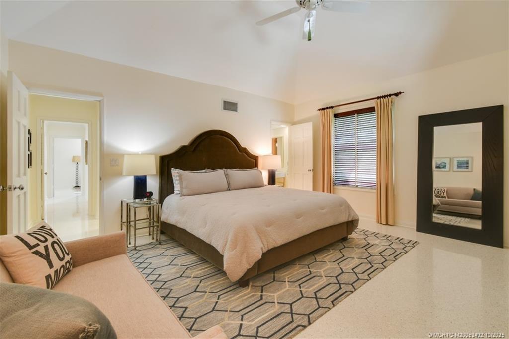 229 Colony Road Jupiter, FL 33469 - Photo 19 of 52 a bedroom with a bed and wooden floor